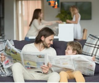 Dad and son reading newspaper