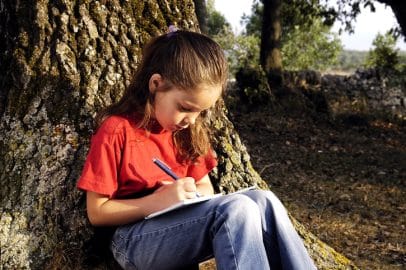 child writing journal